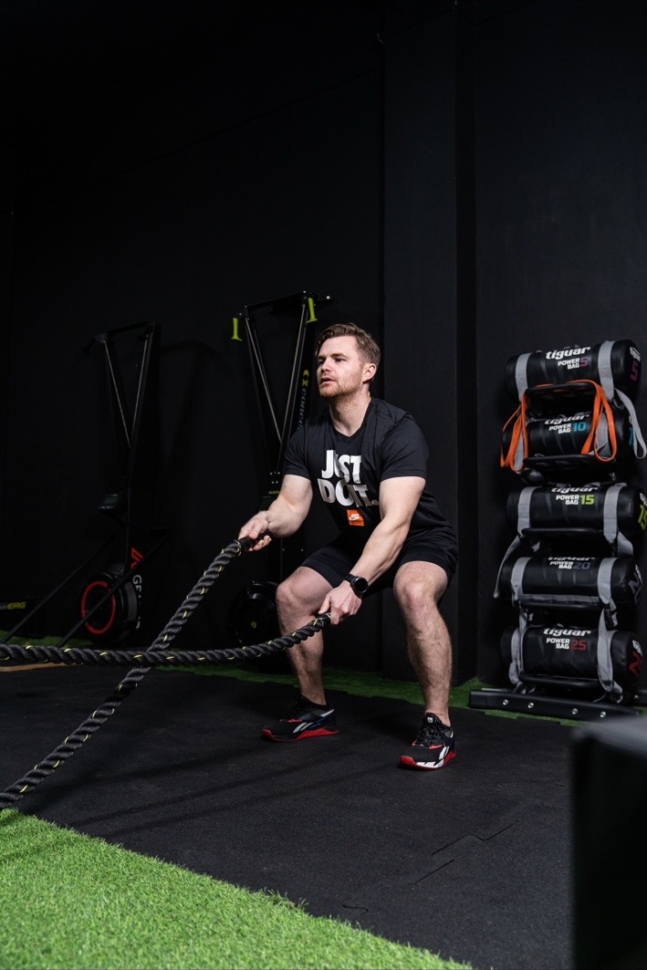Athlete working battle ropes in the Movement Lab studio