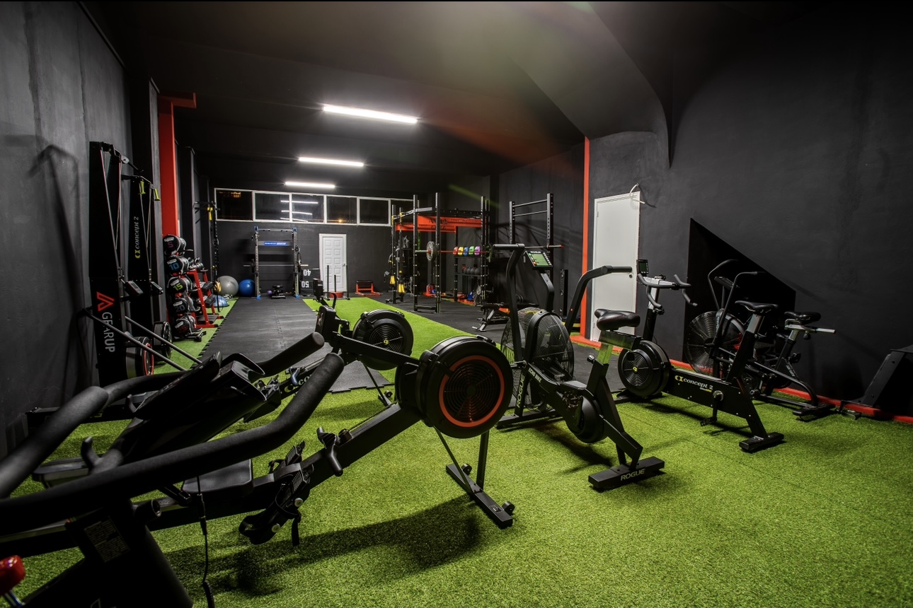 Movement Lab studio interior in Pefki showing cardio rowers, bikes and the turf training lane